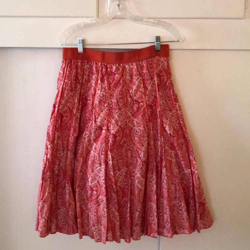 Skirt, 26” long, colors of orange red and cream.